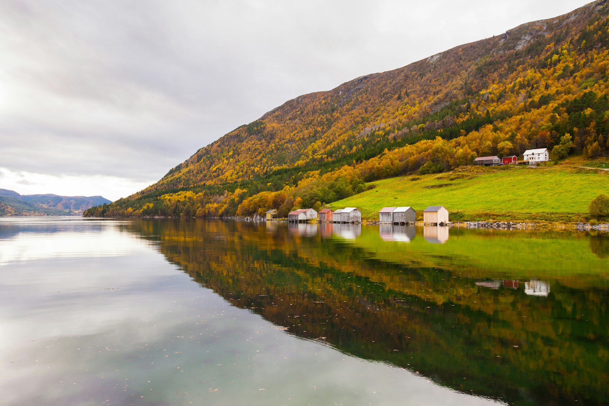 autumn rural landscape with houses near river, Norway